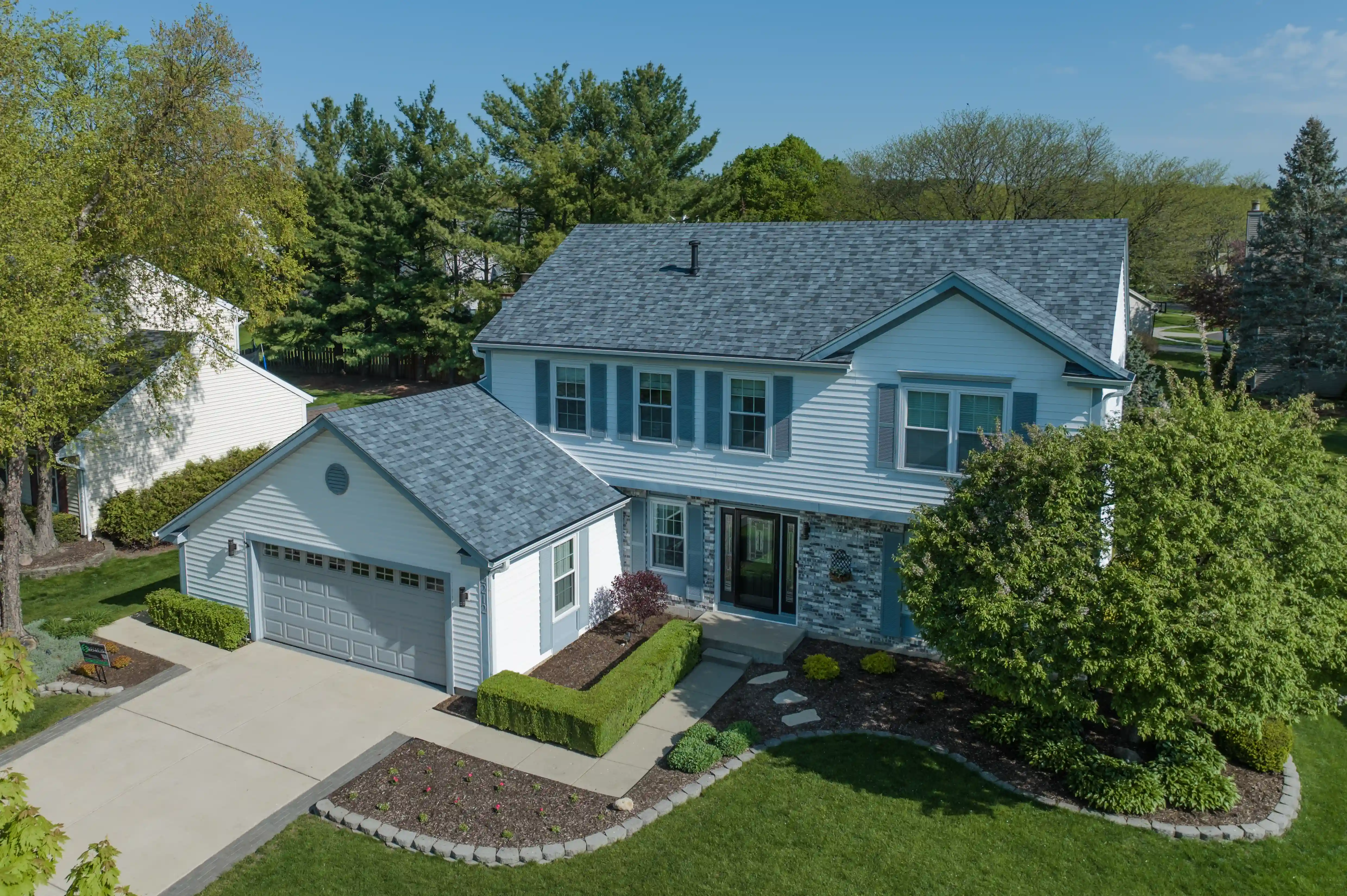 Completed West Dundee IL roof replacement with Owens Corning Slatestone Gray shingles, gutters, and Raindrop gutter guards