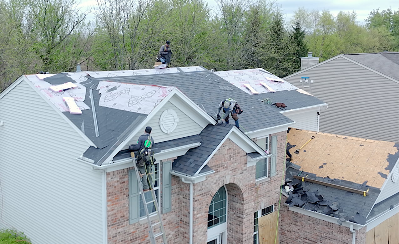 Exterior Echelon crew restoring a storm-damaged roof and exterior system
